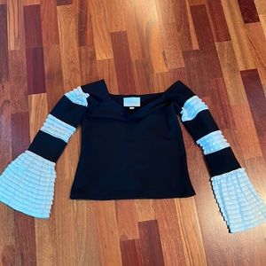 ALEXIS black off- shoulder blouse w/flounces. Purchased at Intermix. Sexy!